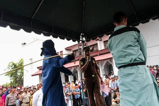 An Acehnese man is whipped in front of the public for violating sharia law in Pidie District on 14 July 2017, Aceh, Indonesia. Aceh is the only one province in Indonesia which has implemented sharia law, which bans sexual contact between men and women who are not married. Whipping is one form of punishment imposed in Aceh for violating Islamic sharia law. (Photo by Oviyandi/Barcroft Images)