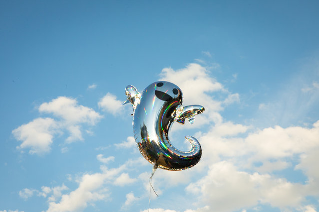 An abandoned balloon floats into the sky at All Things Go on the first day of the music festival, on September 28, 2024 in Columbia, MD. (Photo byMaansi Srivastava for the Washington Post)