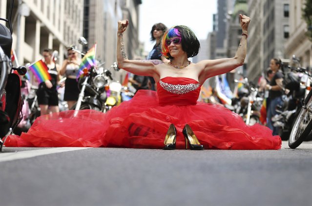 A parade participant sits on Fifth Avenue waiting for start of the New York City Pride Parade on Sunday, June 26, 2016, in New York. (Photo by Mel Evans/AP Photo)