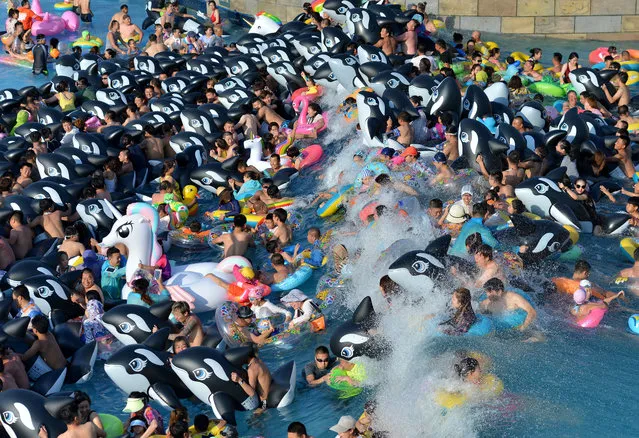 Numerous tourists flock to HotGo Water Park during hot summer in Fushun, northeast China's Liaoning Province on July 30, 2017. (Photo by Sipa Asia/Rex Features/Shutterstock)