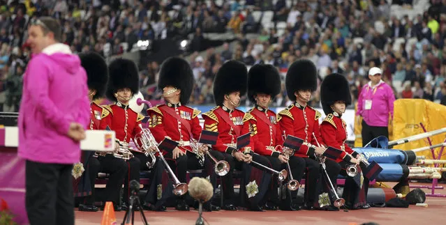 Ceremonial guardsmen sit by the water jump the finals of the pole vault during the World Athletics Championships in London Tuesday, August 8, 2017. (Photo by Leonore Schick/AP Photo)