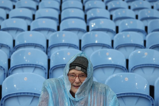 Life-long Villa fan, 80-year-old Margaret Southam takes her seat in the wet weather ahead of the English Premier League football match between Aston Villa and Southampton at Villa Park in Birmingham, central England on December 7, 2024. (Photo by Adrian Dennis/AFP Photo)