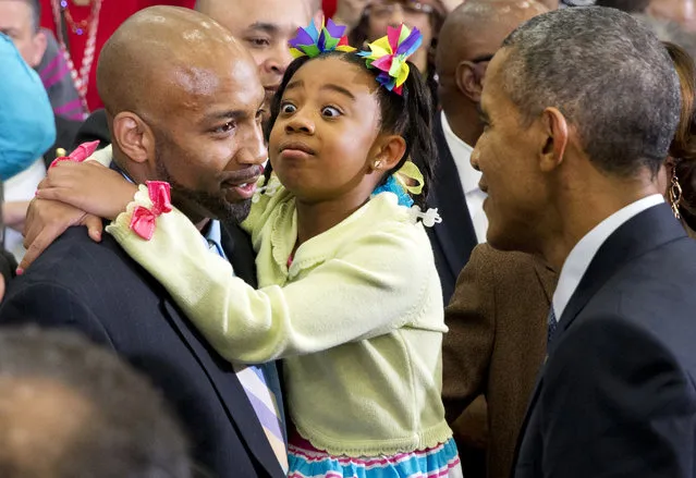 A girl reacts as President Barack Obama greets her and others in the crowd after speaking about payday lending, at Lawson State Community College in Birmingham, Ala., Thursday, March 26, 2015. (Photo by Jacquelyn Martin/AP Photo)