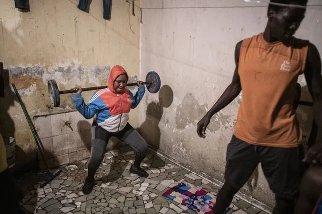 In this photo taken Saturday, April 25, 2020, the family of Bara Tambedou exercises at home after breaking the fast on the first day of the Muslim holy month of Ramadan, in Dakar, Senegal. This year the family is celebrating Ramadan at home, with prohibitions on public gatherings and a dusk-to-dawn curfew in place to curb the spread of the new coronavirus. (Photo by Sylvain Cherkaoui/AP Photo)