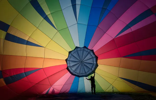 A hot air balloon is prepared to take to the skies at a preview flight to launch next week's Bristol International Balloon Fiesta on August 5, 2016 in Bristol, England. The four day event event, which will officially open next week on Thursday, is now in its 38th year and is Europe's largest annual hot air balloon event in the city that is seen as many as the home of modern ballooning. (Photo by Matt Cardy/Getty Images)