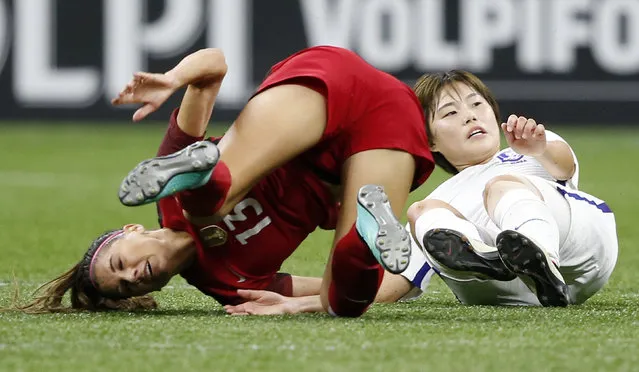 U.S. forward Alex Morgan, left, hits the turf after colliding with South Korea defender Shin Damyeong during the first half of an international friendly women's soccer match in New Orleans, Thursday, October 19, 2017. (Photo by Gerald Herbert/AP Photo)