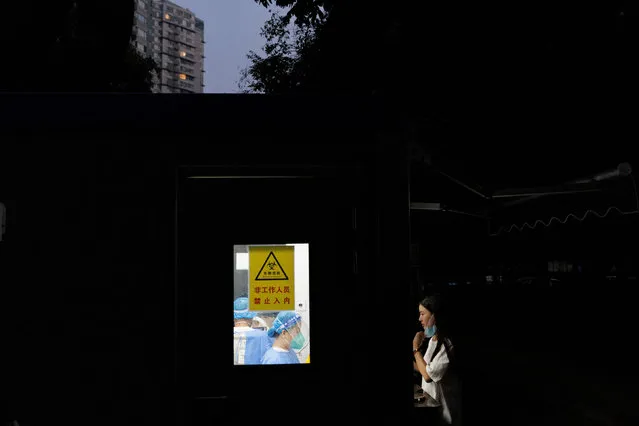 A woman gets a swab at a nucleic acid testing station, set up city-wide to trace possible coronavirus disease (COVID-19) outbreaks in Beijing, China on September 13, 2022. (Photo by Thomas Peter/Reuters)