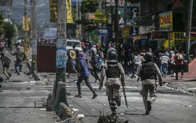 Police chase looters from a depot during a protest against fuel price hikes and to demand that Haitian Prime Minister Ariel Henry step down, in Port-au-Prince, Haiti, Thursday, September 15, 2022. (Photo by Joseph Odelyn/AP Photo)