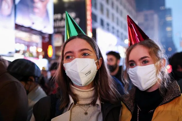 People gather to take part in the New Year's Eve celebrations in Times Square, as the Omicron coronavirus variant continues to spread, in the Manhattan borough of New York City, U.S., December 31, 2021. (Photo by Hannah Beier/Reuters)