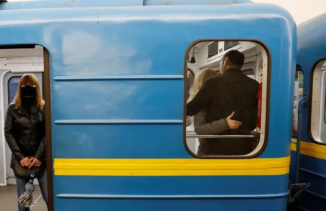 A couple share a kiss inside a train, after the city metro was reopened as part of another stage to ease the coronavirus disease (COVID-19) restrictions in Kiev, Ukraine on May 25, 2020. (Photo by Gleb Garanich/Reuters)
