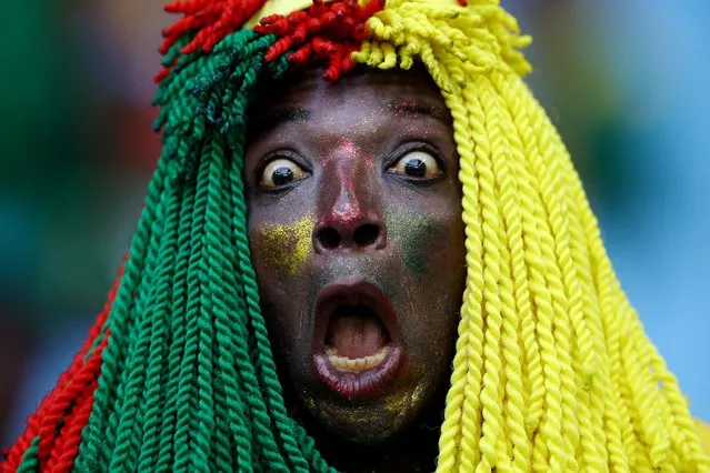 A Cameroon fan waits for the start of the Qatar 2022 World Cup Group G football match between Switzerland and Cameroon at the Al-Janoub Stadium in Al-Wakrah, south of Doha on November 24, 2022. (Photo by Hannah Mckay/Reuters)