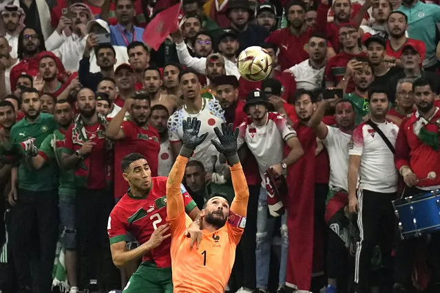 France's goalkeeper Hugo Lloris, right, and Morocco's Achraf Hakimi challenge for the ball during the World Cup semifinal soccer match between France and Morocco at the Al Bayt Stadium in Al Khor, Qatar, Wednesday, December 14, 2022. (Photo by Martin Meissner/AP Photo)