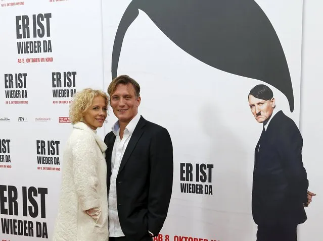 Actors Katja Riemann (L) and Oliver Masucci walk on the red carpet at the world premier of the film 'Look Who's Back' in Berlin, Germany, October 6, 2015. The film 'Look Who's Back' is an adaptation of a satirical novel by Timur Vermes about Adolf Hitler. (Photo by Fabrizio Bensch/Reuters)