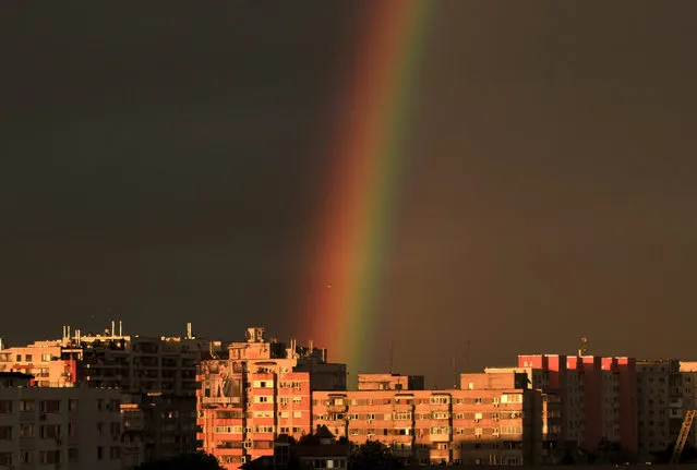 Communist era apartment blocks are back dropped by a rainbow at sunset in Bucharest, Sunday, May, 3, 2015. The rainbow formed after a thunderstorm hit the Romanian capital in the late afternoon. (Photo by Vadim Ghirda/AP Photo)