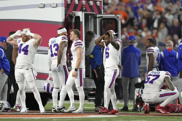 Buffalo Bills players react as teammate Damar Hamlin is examined during the first half of an NFL football game against the Cincinnati Bengals, Monday, January 2, 2023, in Cincinnati. (Photo by Jeff Dean/AP Photo)