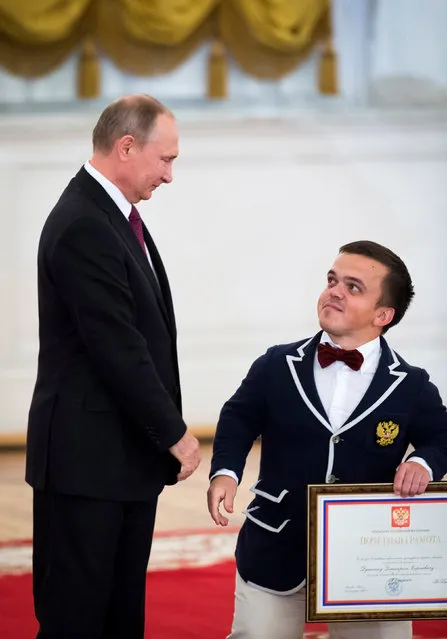 Russian President Vladimir Putin meets Dmitry Dushkin, member of the Russian summer sports Paralympic team in the men's shot put discipline,  at the Kremlin in Moscow, Russia September 19, 2016. (Photo by Ivan Sekretarev/Reuters)