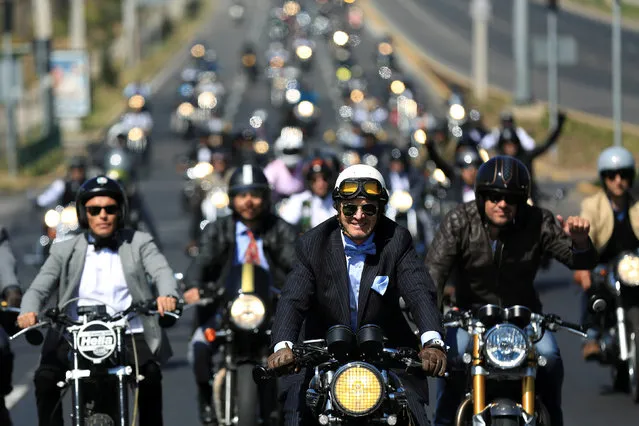 People ride motorcycles during “The Distinguished Gentleman’s Ride” vintage motorcycles race, as part of a campaign to raise awareness on prostate cancer, in Santiago, Chile September 25, 2016. (Photo by Pablo Sanhueza/Reuters)