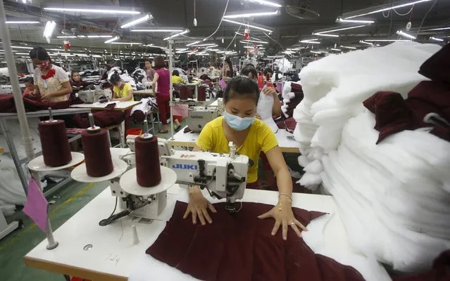 Labourers work to make Zara jackets at a garment factory in Bac Giang province, near Hanoi October 21, 2015. (Photo by Reuters/Kham)