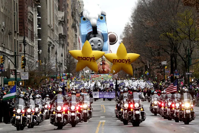 Police officers ride motorcycles while leading the start of the Macy's Thanksgiving Day Parade, Thursday, November 27, 2014, in New York. (Photo by Julio Cortez/AP Photo)