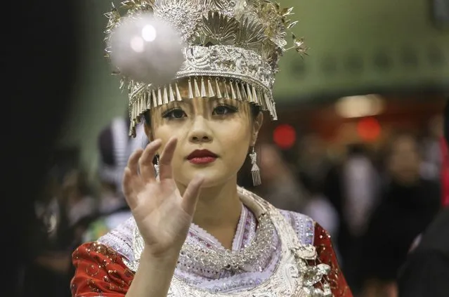 Gaoshoua Moua of Rochester wears Hmong Chinese decor while participating in the ball toss at the Minnesota Hmong New Year celebration Saturday, November 29, 2014, at the Saint Paul RiverCentre in St. Paul, MN. The annual Minnesota Hmong New Year celebration will be held at the Saint Paul RiverCentre November 28–30. Hmong New Year has a deep cultural significance to the Hmong community. It is a celebration of accomplishments during the past year and a time to welcome a new beginning. (Photo by David Joles/Star Tribune)