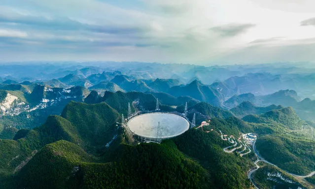 This aerial panorama photo taken on Feb. 13, 2023 shows China's Five-hundred-meter Aperture Spherical Radio Telescope (FAST) under maintenance in Southwest China's Guizhou Province. FAST, the world's largest single-dish radio telescope, has identified over 740 pulsars since its launch, the research team has announced. Dubbed as the “China Sky Eye”, the telescope is located in a naturally deep and round karst depression in the southwestern province of Guizhou. It has a reception area equal to 30 standard soccer fields. (Photo by Xinhua News Agency/SIPA Press/Rex Features/Shutterstock)
