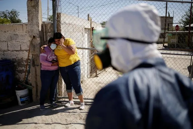 Relatives react outside a house where a person died from the coronavirus disease (COVID-19) in Ciudad Juarez, Mexico on October 22, 2020. (Photo by Jose Luis Gonzalez/Reuters)