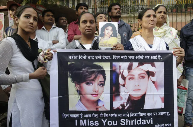 Fans of Bollywood actress Sridevi hold posters as they wait outside her residence to pay their last respects in Mumbai, India, Wednesday, February 28, 2018. Dubai investigators on Tuesday closed the case into the death last weekend of Indian movie icon Sridevi, calling it an accidental drowning. The 54-year-old Sridevi, who was known by only one name, drowned in a hotel bathtub after losing consciousness, officials said. (Photo by Rafiq Maqbool/AP Photo)