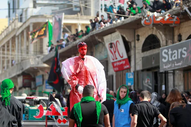 A robot with fake blood is displayed during commemorations for Ashura in Nabatiyeh, Lebanon October 11, 2016. (Photo by Ali Hashisho/Reuters)