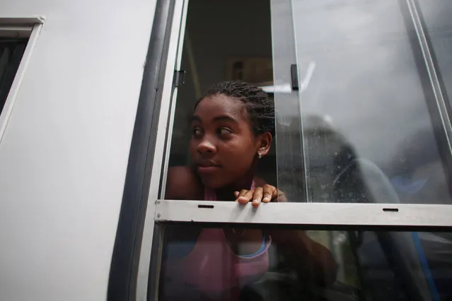 A girl being evacuated peers from the window of a bus ahead of the arrival of Hurricane Matthew in Secilia, Cuba, October 3, 2016. (Photo by Alexandre Meneghini/Reuters)