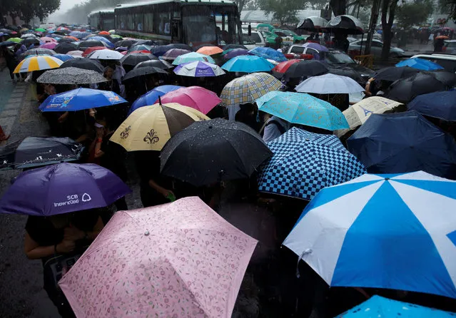 Mourners gather in the rain outside the Grand Palace as they wait to pay their respects to the late King Bhumibol Adulyadej in Bangkok, Thailand October 16, 2016. (Photo by Edgar Su/Reuters)