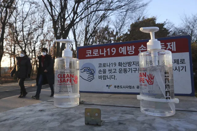 Bottles of hand sanitizer are displayed for use at a park in Goyang, South Korea, Friday, December 4, 2020. The Korea Disease Control and Prevention Agency said Friday that 600 of the newly confirmed patients were domestically transmitted cases – nearly 80 % of them in the densely populous Seoul area, which has been at the center of a recent viral resurgence. The notice reads: “The COVID-19 prevention hand sanitizer”. (Photo by Ahn Young-joon/AP Photo)