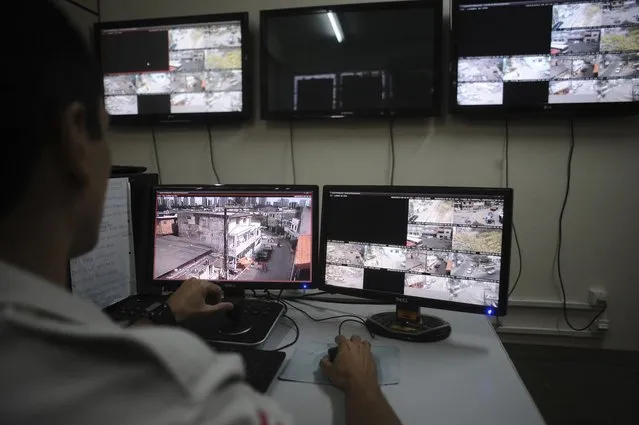 A police officer watches live security cameras aimed at different points of the city where violence is common, at a command center in Salvador, Bahia State, March  28, 2013. (Photo by Lunae Parracho/Reuters)