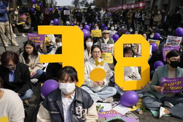 Participants hold signs representing International Women's Day during a rally in Seoul, South Korea, Wednesday, March 8, 2023. (Photo by Lee Jin-man/AP Photo)