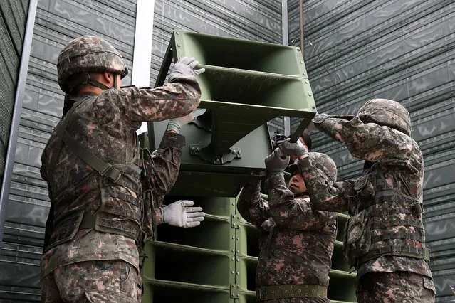 South Korean soldiers take down a propaganda loudspeakers on the border with North Korea on May 1, 2018 in Paju, South Korea. South Korea's military pulled back all high-decibel loudspeakers installed along the border with North Korea in its first step to implement the bilateral summit agreement reached last week. (Photo by Chung Sung-Jun/Getty Images)
