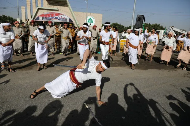 A tribesman performs a traditional dance during a mass wedding held by the Houthis, amid the spread of the coronavirus disease (COVID-19), in Sanaa, Yemen ob December 9, 2020. (Photo by Khaled Abdullah/Reuters)