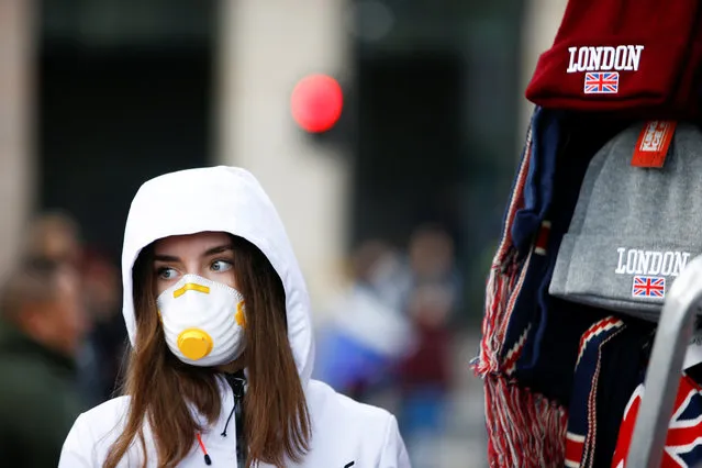 A girl is pictured wearing a protective face mask in London, Britain, March 2, 2020.  British Prime Minister Boris Johnson told reporters Sunday at a health center in London that he was “very, very confident” that Britain’s National Health Service can cope with the coronavirus outbreak. (Photo by Henry Nicholls/Reuters)