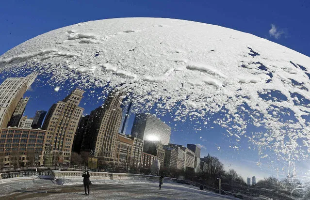 A woman and the Chicago skyline are reflected in the snow covered, curved surface of the “Cloud Gate” sculpture in Chicago, Illinois, January 6, 2015. A bitter cold snap is freezing most of the eastern half of the United States, driving the mercury below zero in the Midwest on Monday, with possible freezing temperatures as far south as Atlanta later this week, forecasters said. (Photo by Jim Young/Reuters)