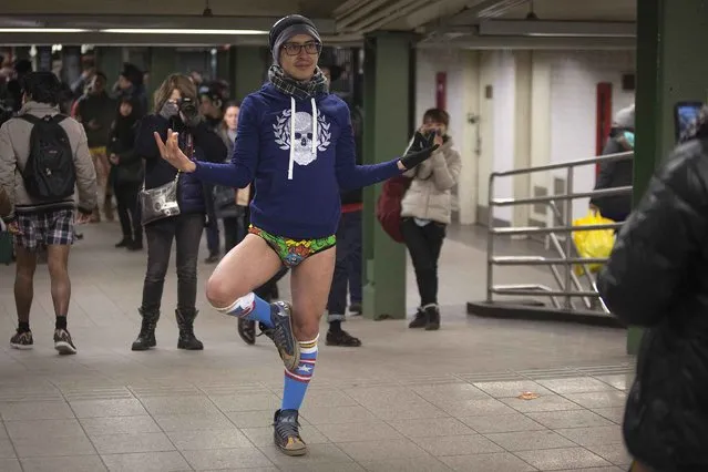 People take photos of a participant taking part in the “No Pants Subway Ride” in the Manhattan borough of New York January 11, 2015. (Photo by Carlo Allegri/Reuters)