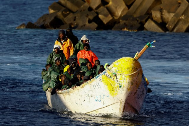 A fibreglass boat with migrants arrives at the port of La Restinga on the island of El Hierro, Spain, on September 30, 2024. (Photo by Borja Suarez/Reuters)