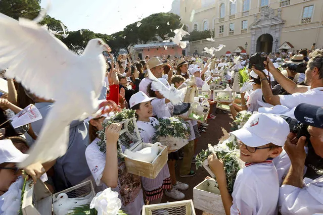 High school students release doves during a commemoration to mark the 100th anniversary of the late Rainier III, in Monaco Wednesday, May 31, 2023. The Principality of Monaco is celebrating the centenary of the birth of Prince Rainier III, whose reign was marked by a strong urban development of the Principality. (Photo by Eric Galliard/Pool via AP Photo)