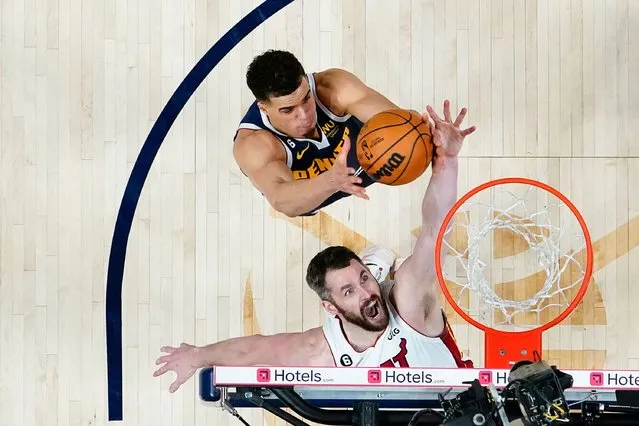 Miami Heat forward Kevin Love, bottom, reaches for a loose ball against Denver Nuggets forward Michael Porter Jr. during the second half of Game 2 of basketball's NBA Finals, Sunday, June 4, 2023, in Denver. (Photo by Kyle Terada/Pool Photo via AP Photo)