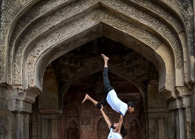 Youth enthusiasts take part in a yoga session at Lodhi gardens on International Day of Yoga, in New Delhi on June 21, 2023. (Photo by Arun Sankar/AFP Photo)