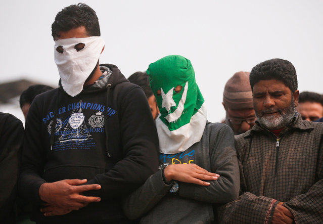 Masked protesters offer funeral prayers of Ghulam Mohammad Khan, a civilian who according to local media succumbed to injuries from a teargas shell fired by Indian police during a protest earlier this month, in Srinagar, November 17, 2016. (Photo by Danish Ismail/Reuters)