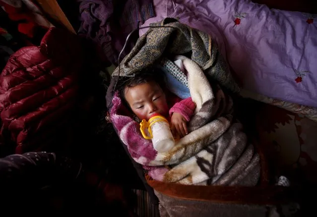 Pasang Choti Sherpa, whose father, Lakpa Sherpa, who was among the 16 sherpas who died in the avalanche on April 18, 2014, lies on her bed inside her house in Khumjung, a typical Sherpa village in Solukhumbu District, also known as the Everest region, in this picture taken November 30, 2015. (Photo by Navesh Chitrakar/Reuters)