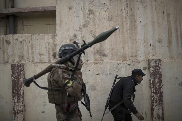 Iraqi special forces advance towards Islamic State militant-held territory in Mosul, Iraq, Wednesday, November 16, 2016. Troops have established a foothold in the city's east from where they are driving northward into the Tahrir neighborhood. The families in Tahrir are leaving their homes to flee the fighting. (Photo by Felipe Dana/AP Photo)