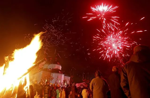 Burning Yule logs and fireworks are seen in front of the Church of the Holy Prophet Elijah during the eve of the Orthodox Christmas in Sokolac, Bosnia and Herzegovina, January 6, 2016. (Photo by Dado Ruvic/Reuters)