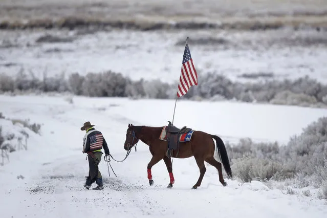 Cowboy Dwane Ehmer, of Irrigon, Ore., a supporter of the group occupying the Malheur National Wildlife Refuge, walks his horse Thursday, January 7, 2016, near Burns, Ore. The group has said repeatedly that local people should control federal lands, but critics say the lands are already managed to help everyone from ranchers to recreationalists. (Photo by Rick Bowmer/AP Photo)