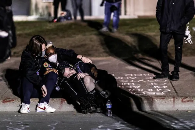 Demonstrators rest outside the Brooklyn Center Police Department, as protests continue days after Daunte Wright was shot and killed by a police officer, in Brooklyn Center, Minnesota, April 17, 2021. (Photo by Leah Millis/Reuters)