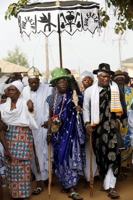 Voodoo chief priest Dagbo (C) walks with other devotees during a traditional street procession at the beginning of the annual voodoo festival in Ouidah January 10, 2016. (Photo by Akintunde Akinleye/Reuters)