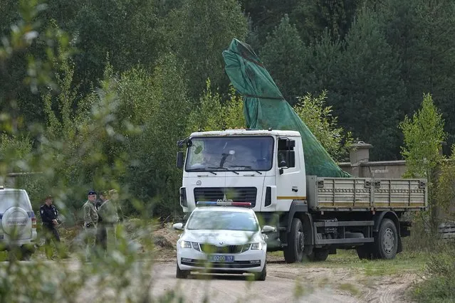 A truck carries a part of a private jet crashed near the village of Kuzhenkino, Tver region, Russia, Friday, August 25, 2023. A preliminary U.S. intelligence assessment has found that the plane crash presumed to have killed Wagner leader Yevgeny Prigozhin was intentionally caused by an explosion. (Photo by Alexander Zemlianichenko/AP Photo)